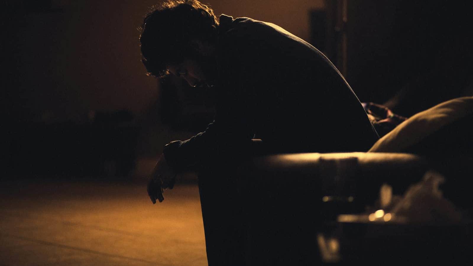 man in black shirt sitting on chair