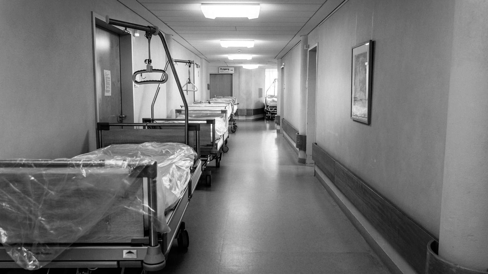grayscale photo of hospital bed